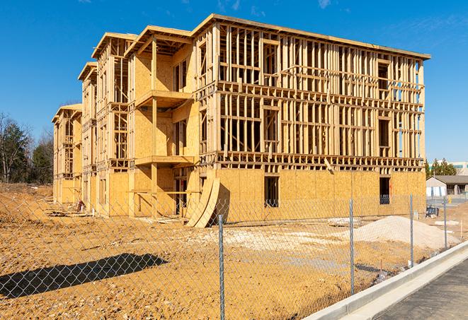 a close-up of temporary chain link fences enclosing a construction site, signaling progress in the project's development in Atlantis, FL