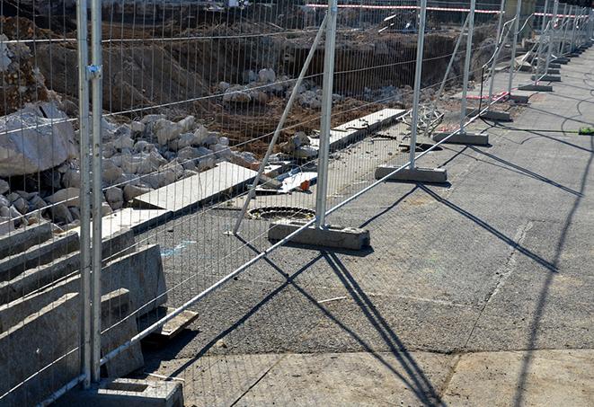 a metal temporary fence designed to keep out intruders from the construction site